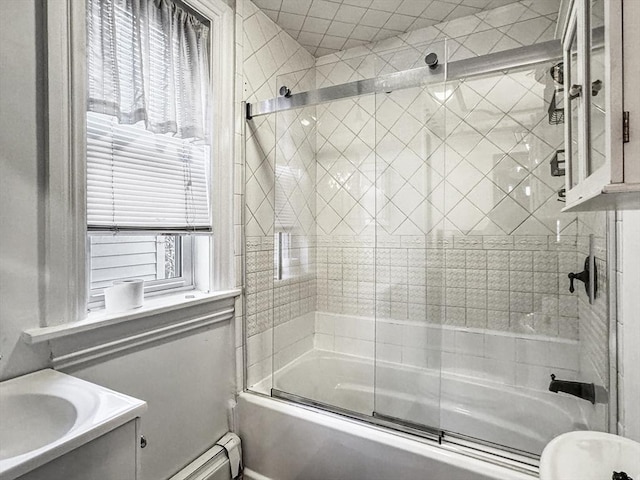 bathroom with vanity, enclosed tub / shower combo, a baseboard radiator, and a wealth of natural light