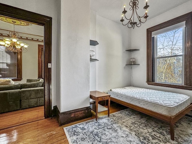 sitting room with wood-type flooring and a chandelier