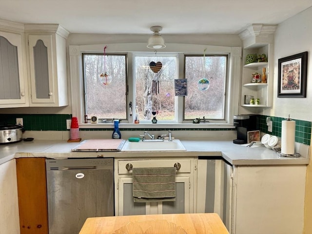 kitchen featuring dishwasher, tasteful backsplash, white cabinets, and sink