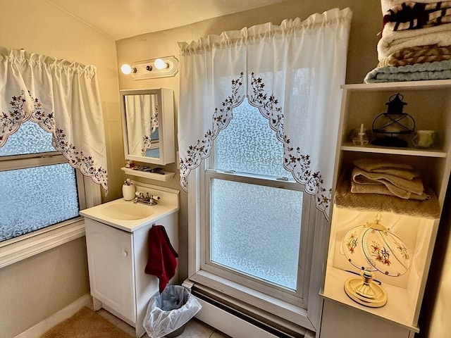 bathroom with baseboard heating and vanity