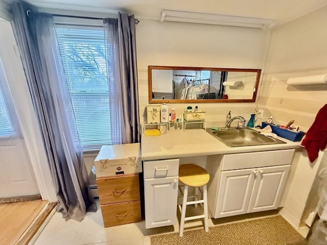 bathroom with tile patterned floors, vanity, and a baseboard radiator