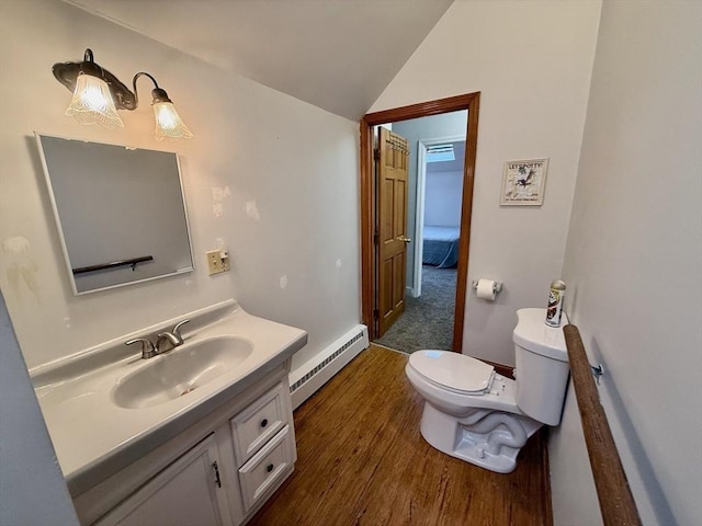 bathroom with vanity, a baseboard heating unit, hardwood / wood-style floors, toilet, and lofted ceiling