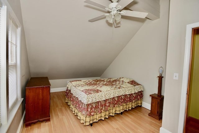 bedroom with hardwood / wood-style floors, ceiling fan, and lofted ceiling