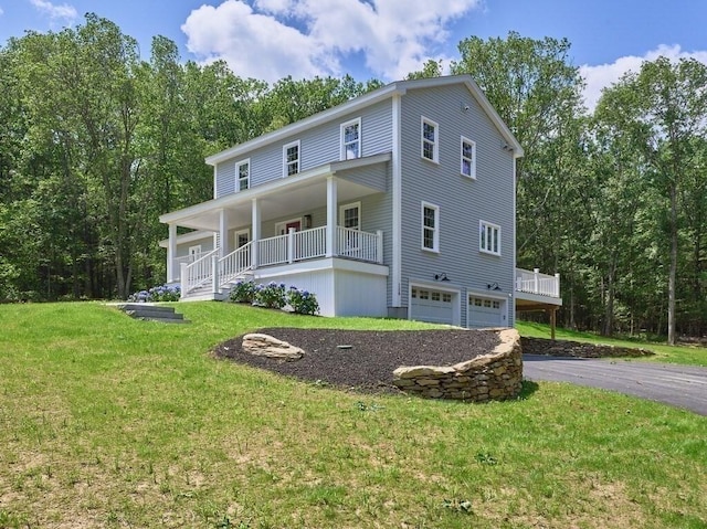 128 Old Southbridge Rd, Dudley, MA 01571 - view of front facade with driveway, a garage, a front lawn, and a porch