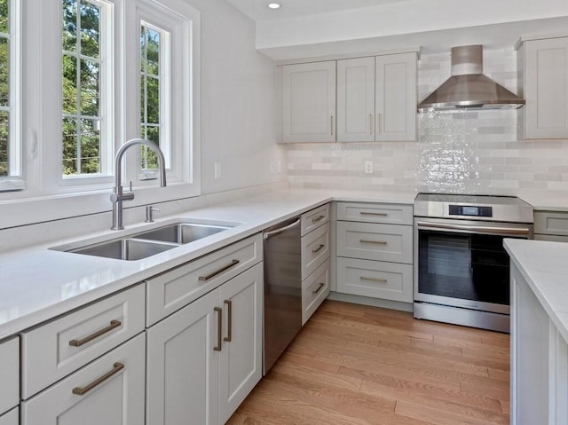 128 Old Southbridge Rd, Dudley, MA 01571 - kitchen featuring appliances with stainless steel finishes, wall chimney range hood, healthy amount of natural light, light countertops, and recessed lighting
