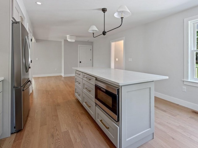 128 Old Southbridge Rd, Dudley, MA 01571 - kitchen with appliances with stainless steel finishes, light countertops, light wood finished floors, a center island, and recessed lighting