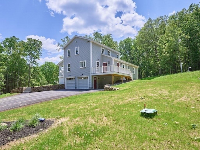 128 Old Southbridge Rd, Dudley, MA 01571 - back of property featuring a garage, driveway, and a lawn