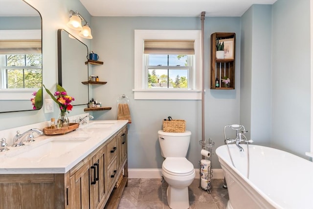 38 Davis St, Plymouth, MA 02360 - bathroom with healthy amount of natural light, baseboards, a freestanding tub, and toilet