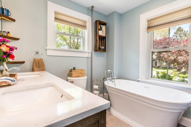 38 Davis St, Plymouth, MA 02360 - bathroom with healthy amount of natural light, a freestanding bath, and double vanity