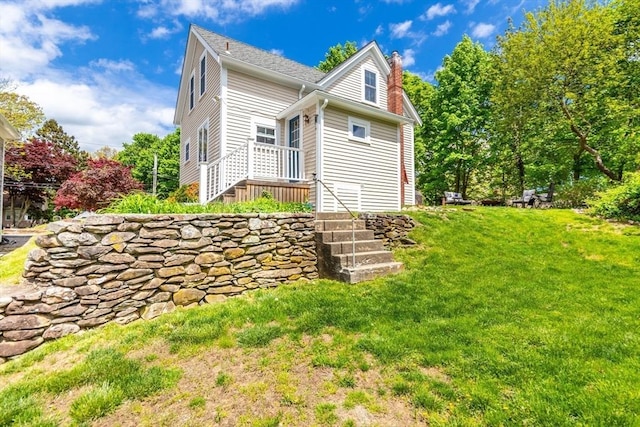 38 Davis St, Plymouth, MA 02360 - view of home's exterior featuring a chimney and a yard