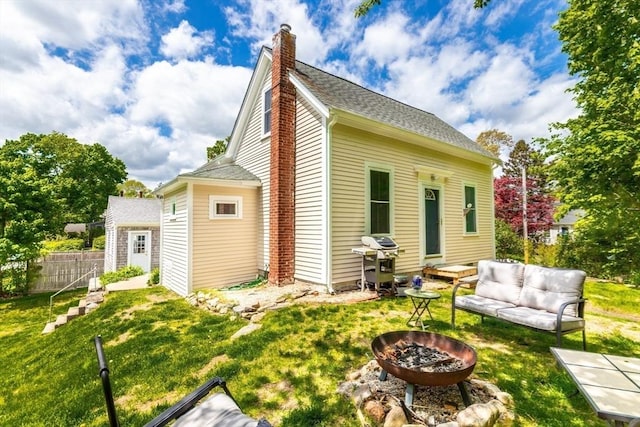 38 Davis St, Plymouth, MA 02360 - back of property featuring a chimney and an outdoor living space with a fire pit