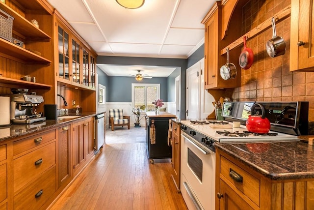 38 Davis St, Plymouth, MA 02360 - kitchen featuring white gas range, brown cabinets, a sink, stainless steel dishwasher, and a wainscoted wall