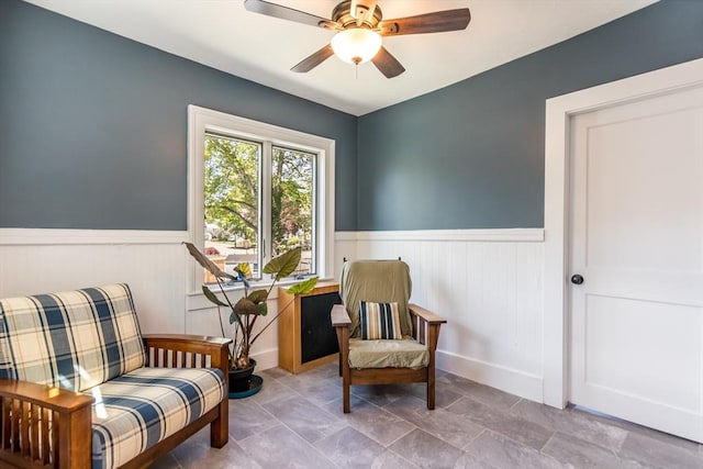 38 Davis St, Plymouth, MA 02360 - living area featuring a wainscoted wall, ceiling fan, and baseboards