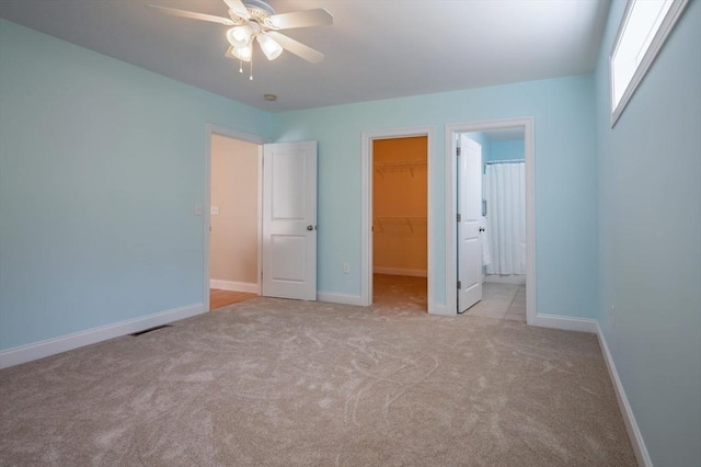 21 Cielo Dr, Dover, NH 03820 - unfurnished bedroom featuring carpet, a walk in closet, a closet, and a ceiling fan