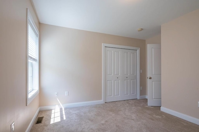 21 Cielo Dr, Dover, NH 03820 - unfurnished bedroom featuring multiple windows, carpet floors, and a closet