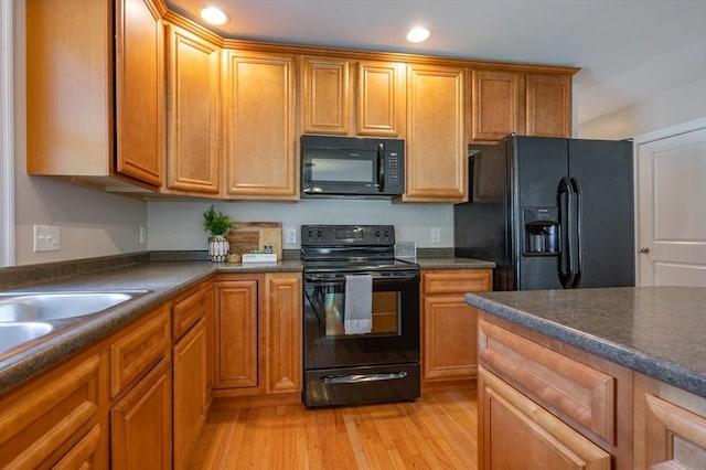 21 Cielo Dr, Dover, NH 03820 - kitchen featuring black appliances, dark countertops, light wood-style floors, recessed lighting, and brown cabinets