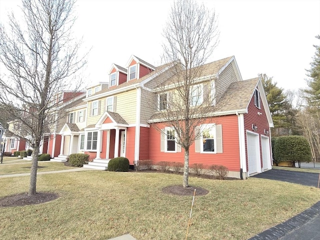 view of front of house featuring a garage and a front lawn