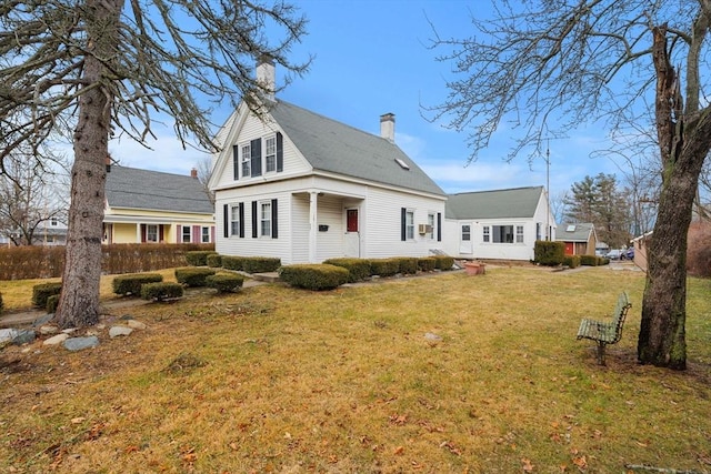 exterior space with a front lawn and a chimney