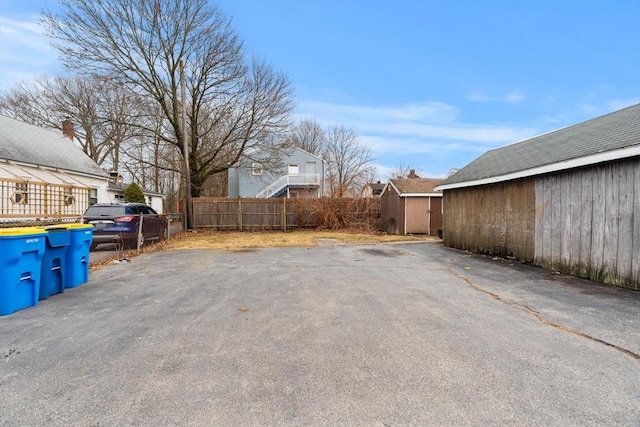 exterior space featuring a shed and fence