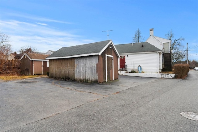 exterior space with an outbuilding and a storage unit