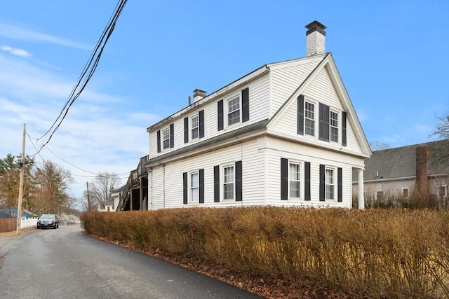 view of side of property featuring a chimney