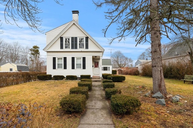 view of front of property with a chimney and a front yard