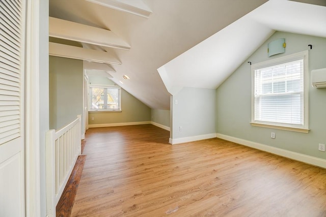 bonus room featuring baseboards, vaulted ceiling, and light wood finished floors