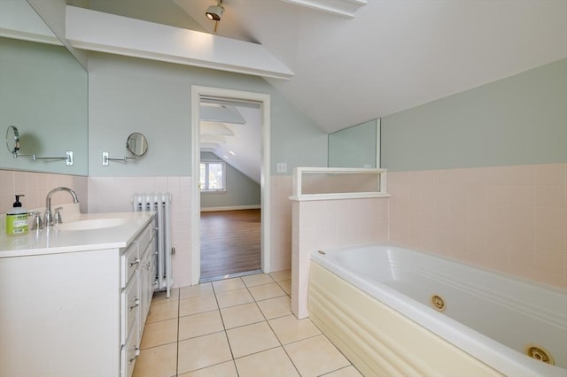 full bath featuring tile patterned flooring, radiator, a whirlpool tub, tile walls, and lofted ceiling