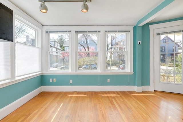 unfurnished sunroom featuring plenty of natural light