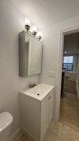 bathroom with tile patterned floors, vanity, and baseboards
