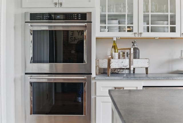 4 Porter St, Granby, MA 01033 - kitchen featuring double oven, glass insert cabinets, white cabinetry, and light stone countertops