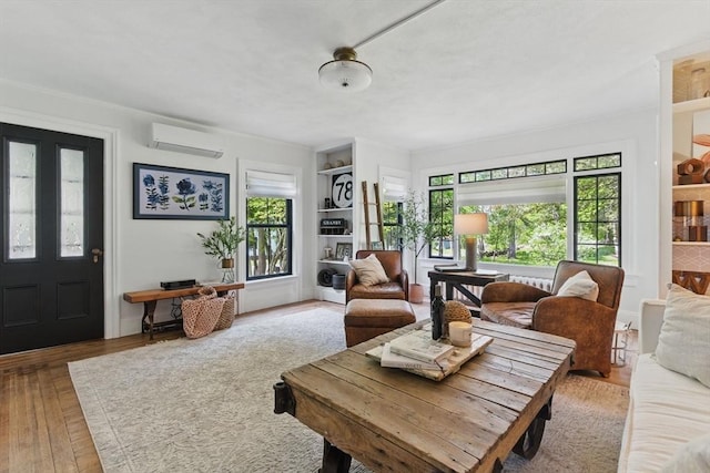 4 Porter St, Granby, MA 01033 - living room with an AC wall unit, wood finished floors, and built in features