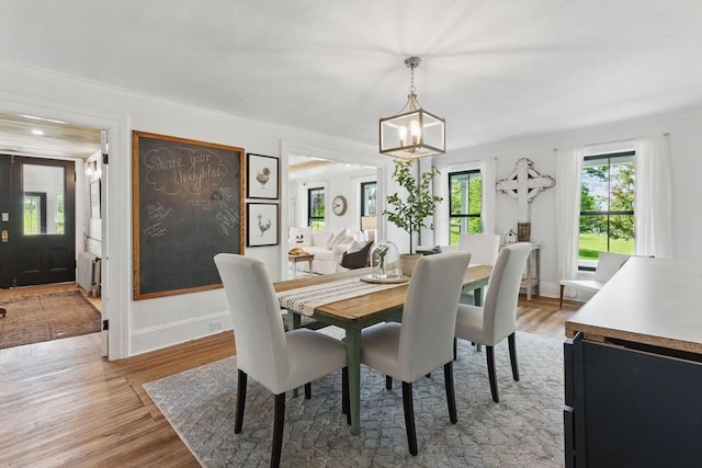 4 Porter St, Granby, MA 01033 - dining space featuring a chandelier, plenty of natural light, light wood-type flooring, and crown molding