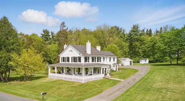 4 Porter St, Granby, MA 01033 - rear view of house featuring covered porch, a yard, an outdoor structure, a chimney, and a wooded view