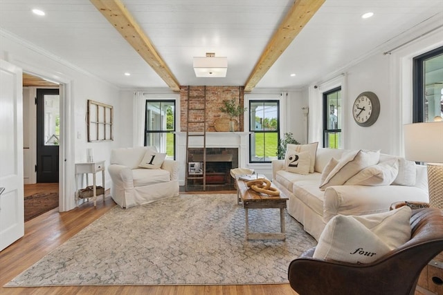 4 Porter St, Granby, MA 01033 - living area with wood finished floors, beamed ceiling, a fireplace, and ornamental molding