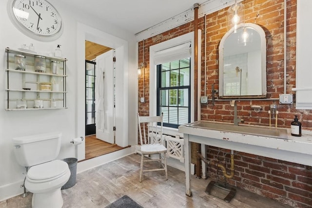 4 Porter St, Granby, MA 01033 - full bath with brick wall, wood finished floors, toilet, a shower, and baseboards