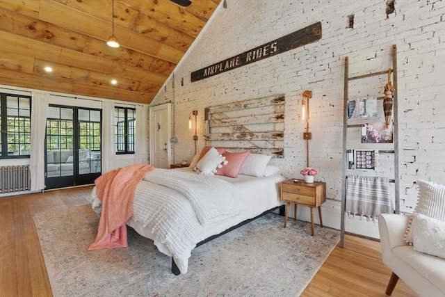 4 Porter St, Granby, MA 01033 - bedroom with wood finished floors, french doors, access to outside, radiator, and high vaulted ceiling