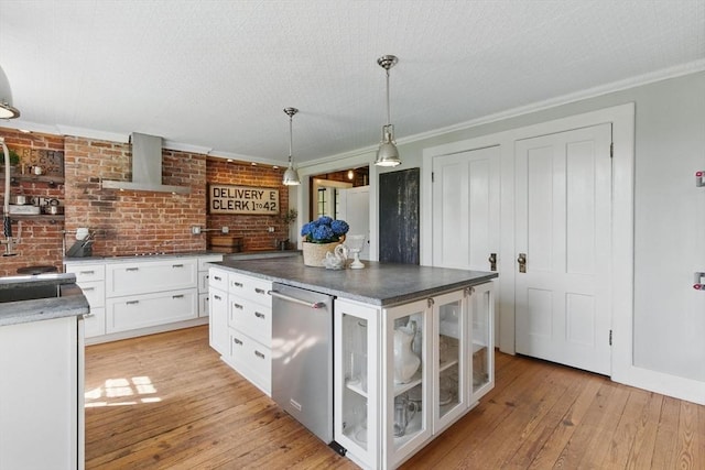 4 Porter St, Granby, MA 01033 - kitchen with wall chimney range hood, ornamental molding, white cabinetry, light wood-style flooring, and stainless steel dishwasher