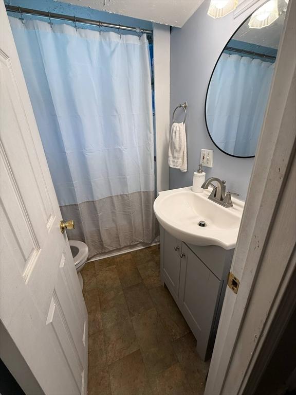 31 Abbott St, Lowell, MA 01852 - bathroom with vanity and a shower with shower curtain