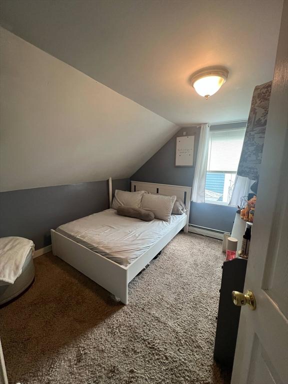 31 Abbott St, Lowell, MA 01852 - bedroom with carpet floors, lofted ceiling, and a baseboard radiator