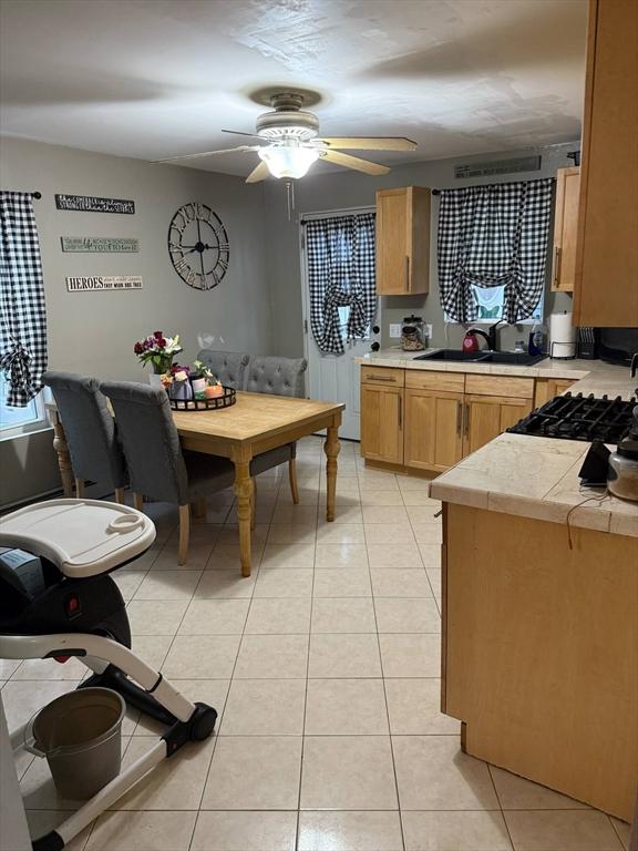 31 Abbott St, Lowell, MA 01852 - kitchen featuring ceiling fan and light tile patterned flooring