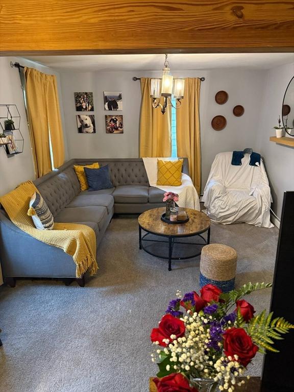 31 Abbott St, Lowell, MA 01852 - carpeted living area featuring a chandelier