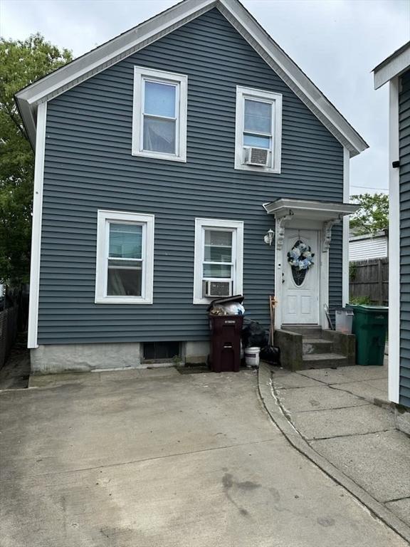 31 Abbott St, Lowell, MA 01852 - back of property featuring a patio area and cooling unit