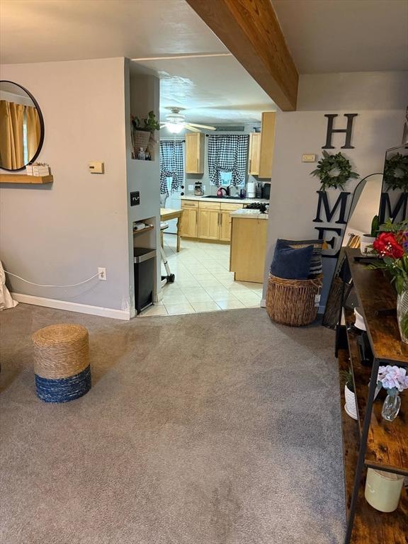 31 Abbott St, Lowell, MA 01852 - living area featuring light colored carpet, light tile patterned flooring, and a ceiling fan