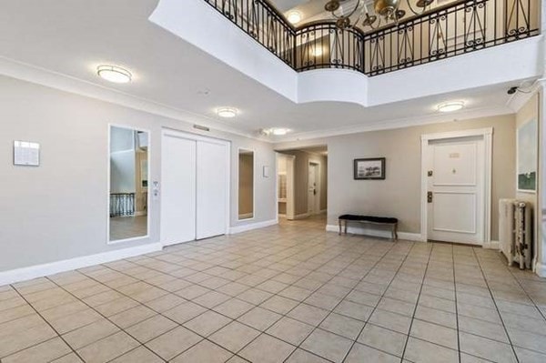 interior space featuring radiator, ornamental molding, and a high ceiling