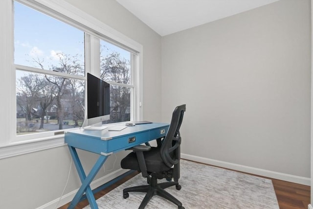 office area with dark wood-type flooring and baseboards