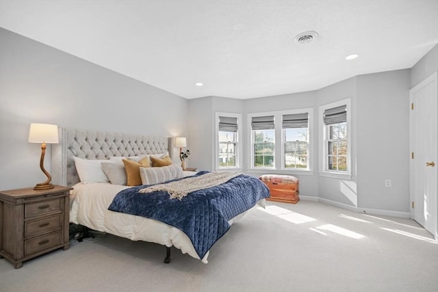 bedroom with light carpet, recessed lighting, visible vents, and baseboards