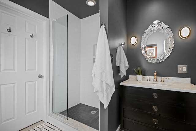 bathroom featuring a tile shower and vanity