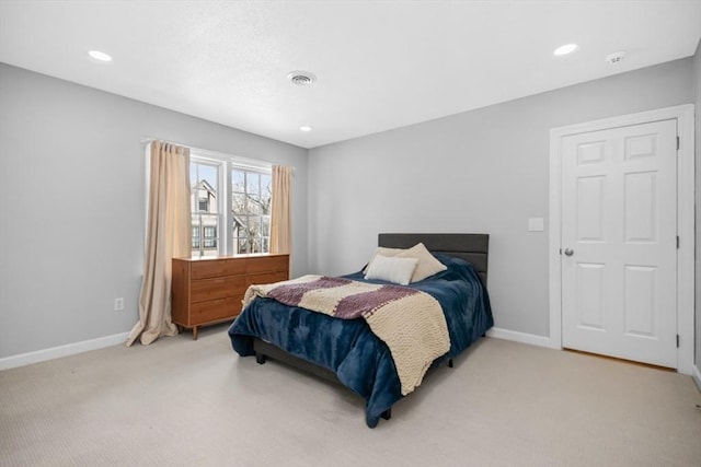 carpeted bedroom with recessed lighting, visible vents, and baseboards