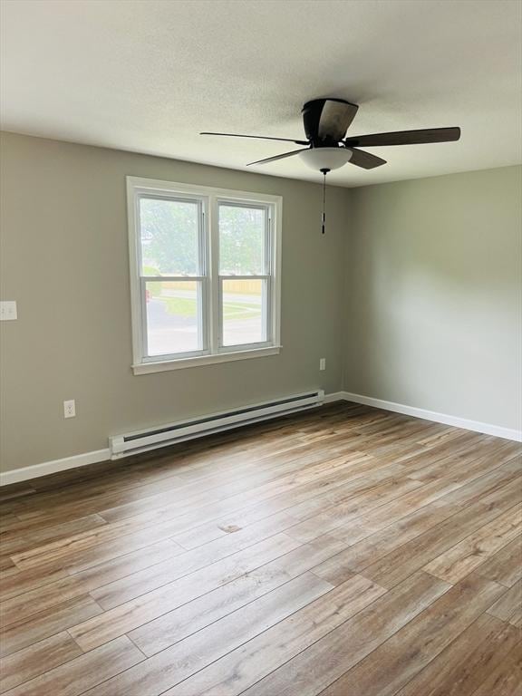 209 Casey Dr, Chicopee, MA 01020 - spare room with baseboard heating, wood finished floors, and a ceiling fan